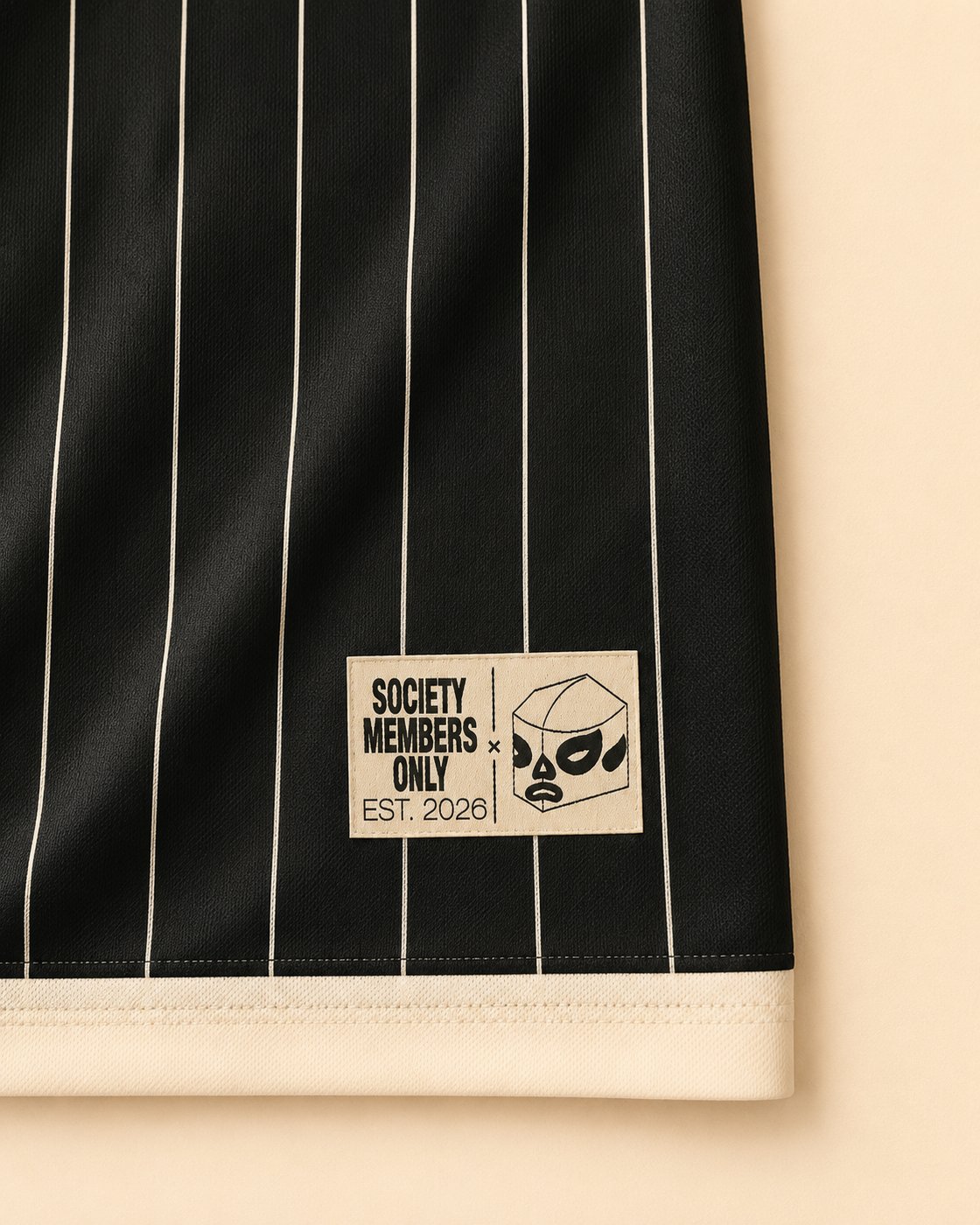 Society Members Only Est. 2026 tag on the hem of the Society Jersey